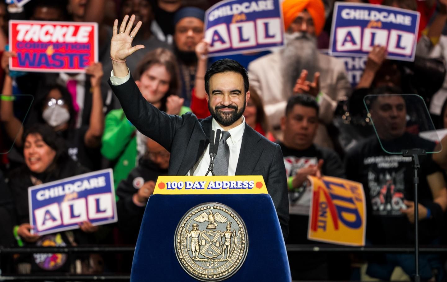 Zohran Mamdani, Mayor of New York City, waving from the podium at his 100-day address.